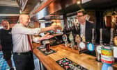 Prime Minister Andy Burnham, right, and Chancellor of the Exchequer John Healey during a visit to a pub in Harlow, Essex