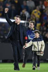 Union SG head coach Sebastien Pocognoli celebrates as he leaves the pitch with his son after winning the Belgian "Pro League" First Division playoff against Genk at the Joseph Marien Stadium, in Brussels on May 3, 2025.