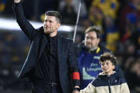 Union SG head coach Sebastien Pocognoli celebrates as he leaves the pitch with his son after winning the Belgian "Pro League" First Division playoff against Genk at the Joseph Marien Stadium, in Brussels on May 3, 2025.
