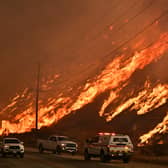 A wildfire rages on a hillside in Castaic, a north-western neighbourhood of Los Angeles, California, last year (Picture: Frederic J Brown)
