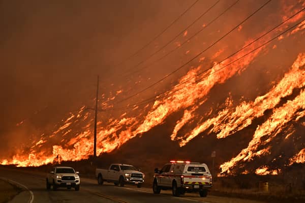 A wildfire rages on a hillside in Castaic, a north-western neighbourhood of Los Angeles, California, last year (Picture: Frederic J Brown)