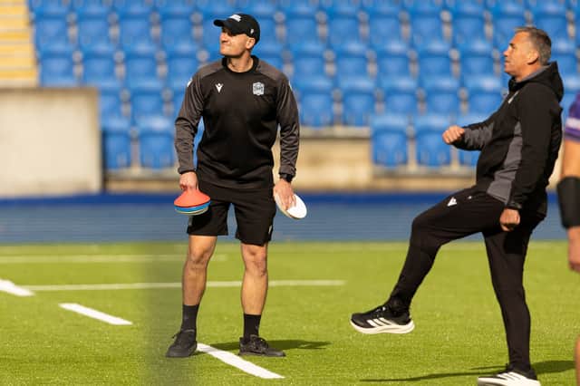 Assistant coach Scott Forrest, left, and head coach Franco Smith get a feel for Glasgow Warriors' new playing surface at Scotstoun Stadium.