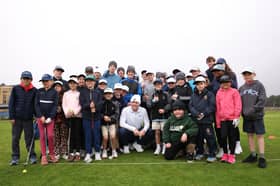 Defending Dunhill Links champion Bob MacIntyre pictured with a group of St Andrews Junior Golf Association players in St Andrews this week 