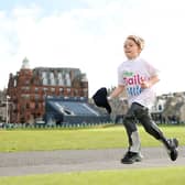 A Daily Mile runner races across the Old Course.