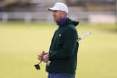 Cricketer Kevin Pietersen prepares to putt.