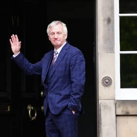 Ivan McKee waves to media