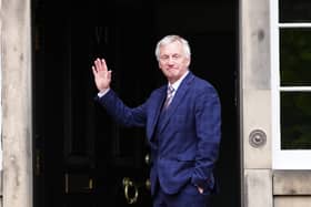Ivan McKee waves to media