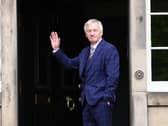 Ivan McKee waves to media