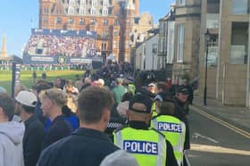 Police officers walk up the 18th hole at St Andrews as Dermot Desmond plays