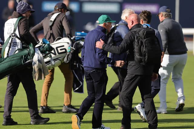Celtic principal shareholder Dermot Desmond (centre) being escorted off by security from the 18th green on day three of the 2026 Alfred Dunhill Links Championship at St Andrews