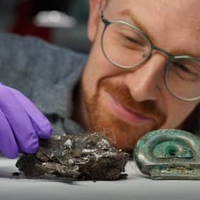 Dr Matthew Knight with a clay mould from the Blyth Hoard and an item from the Peebles Hoard. PIC: Stewart Attwood/National Museums Scotland/PA Wire