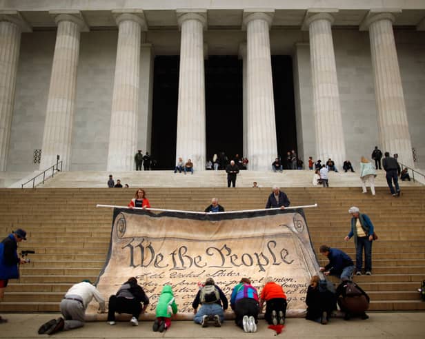 Protesters with a giant banner printed with the Preamble to the United States Constitution during a demonstration against the Supreme Court's Citizens United ruling at the Lincoln Memorial in Washington in 2010 (Picture: Chip Somodevilla)