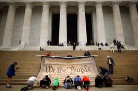 Protesters with a giant banner printed with the Preamble to the United States Constitution during a demonstration against the Supreme Court's Citizens United ruling at the Lincoln Memorial in Washington in 2010 (Picture: Chip Somodevilla)