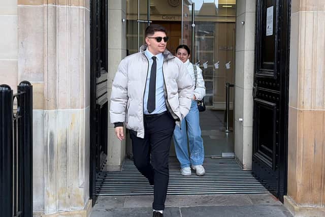 Ilia Belov and and Nadjedzha Belova walking out of a building