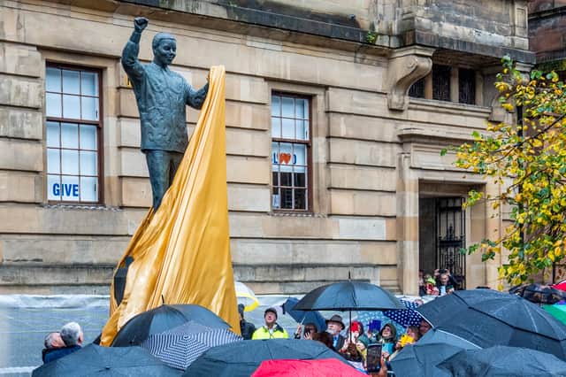 A statue of Nelson Mandela is unveiled by representatives from the Nelson Mandela Scottish Memorial Foundation, in Nelson Mandela Place, Glasgow