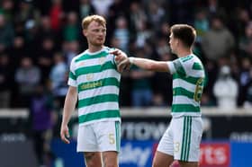 Celtic's Liam Scales (L) passes on instructions to team-mate Kieran Tierney against Motherwell