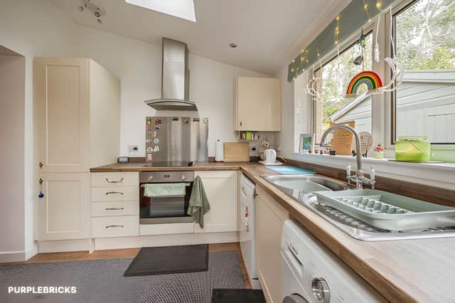A modern fitted kitchen with a range of wall and base units provides practical storage and a dedicated space for everyday cooking