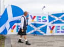 An independence supporter carries a Scottish flag outside the SNP conference in Aberdeen. Picture: Paul Reid
