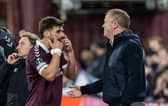 Hearts forward Claudio Braga speaks with head coach Wouter Vrancken after his substitution.