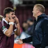 Hearts forward Claudio Braga speaks with head coach Wouter Vrancken after his substitution.