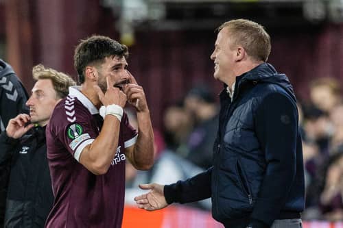 Hearts forward Claudio Braga speaks with head coach Wouter Vrancken after his substitution.