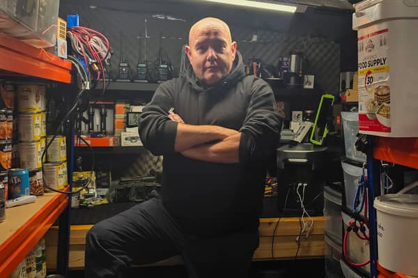 Disaster prepper ‘Brian Forbes' inside his shelter, stocked with a host of supplies