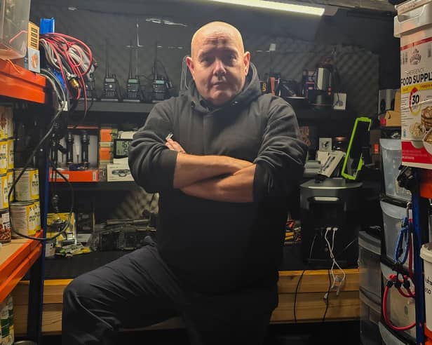 Disaster prepper ‘Brian Forbes' inside his shelter, stocked with a host of supplies