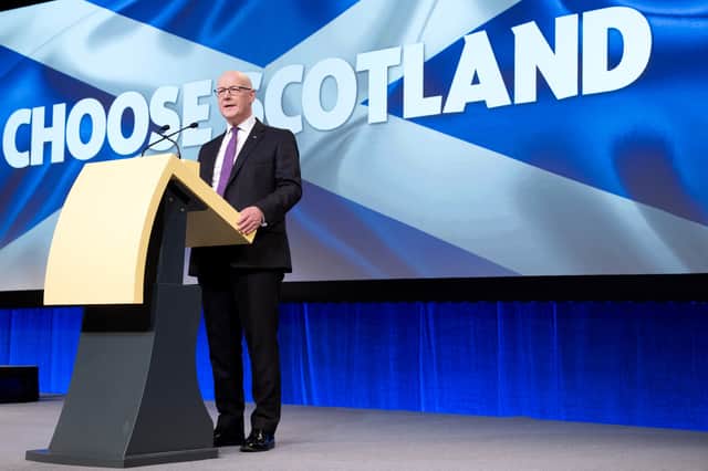 First Minister John Swinney delivering his keynote speech at SNP conference