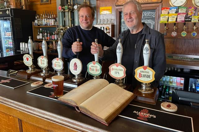Jamie Allsopp and Steve Holt with the Allsopp's ledger