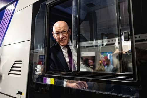 John Swinney in the driver's seat of a First Bus at a trade stand at the SNP party conference in Aberdeen. Picture: Paul Reid