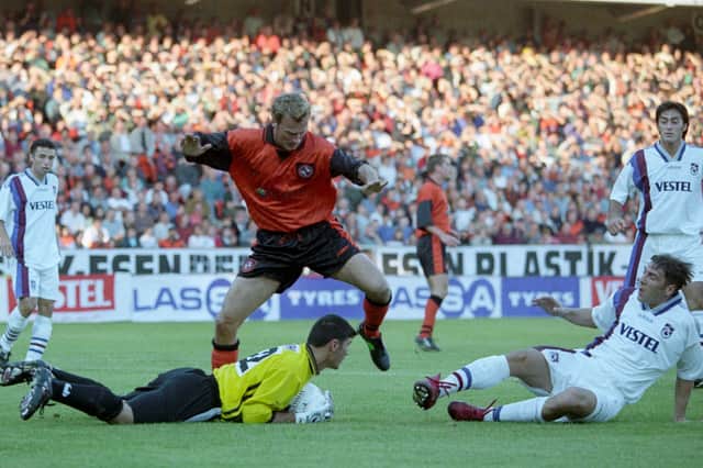 Action from the UEFA Cup qualifying round 2nd leg at Tannadice on August 26, 1997, as Dundee Utd's Lars Zetterlund watches Trabzonspor goalkeeper Metin Aktas claim the ball.