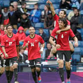 Egypt's Mohamed Salah (top) points as he celebrates on the shoulders of Ahmed Hegazi after scoring his team's first goal against Belarus during the London 2012 Olympic Games men's football match at Hampden Park, Glasgow, on August 1, 2012.