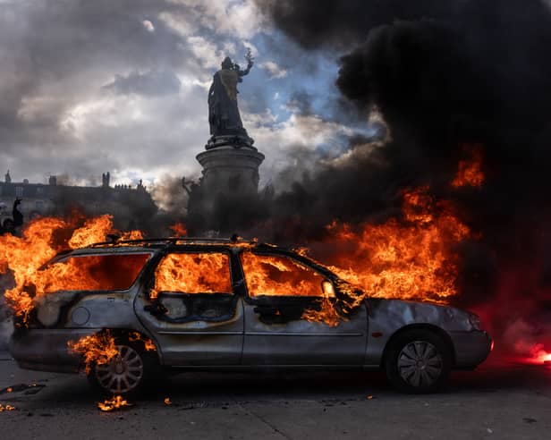A car ablaze during demonstrations in Paris at the weekend