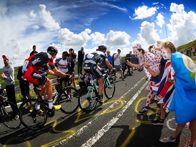 Picture by Simon Hulme/YPN - 06/07/2014 - Cycling - Tour de France 2014: Stage 2, York to Sheffield - Yorkshire, England - Crowds cheer on the cyclist's as they head up the gruelling Holme Moss Climb, Holme Moss Dale, West Yorkshire in the Yorkshire Grand Depart of the 2014 Tour de France. 6th July 2014 -  Cycling fans spectators, flags line the route -

The Grand Depart of the Tour de France 2027 and The Grand Depart of the Tour de France Femmes avec Zwift 2027. Both Races will start in the United Kingdom and visit Scotland, Wales and England - ALL IMAGES © www.SWpix.com ( Photography Hub Ltd ) from the SWpix.com photography archive - MANDATORY BYLINE/PHOTO CREDIT to Photographers Name/SWpix.com/LeTourGB (strictly editorial use only - contact for commercial - simon@swpix.com )