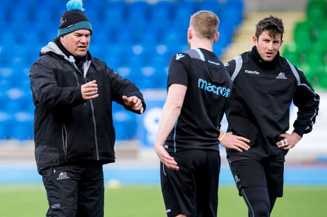 Dave Rennie, left, talks to Finn Russell, centre, during their time together at Glasgow Warriors in 2018.