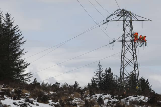 Workers are pictured on a damaged pylon in Kintyre