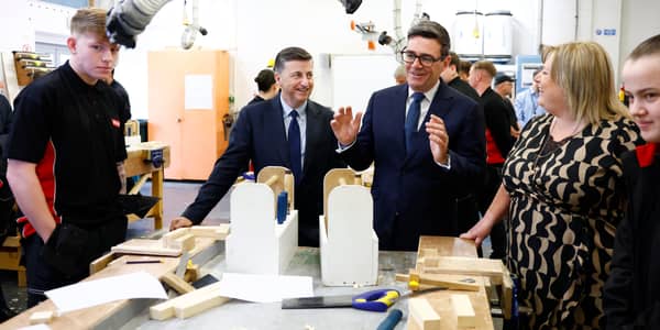 Prime Minister Andy Burnham, right, is accompanied by Secretary of State for Scotland Douglas Alexander during a visit to New College Lanarkshire's Motherwell Campus ahead of a speech focusing on the forming of closer ties with the Scottish government
