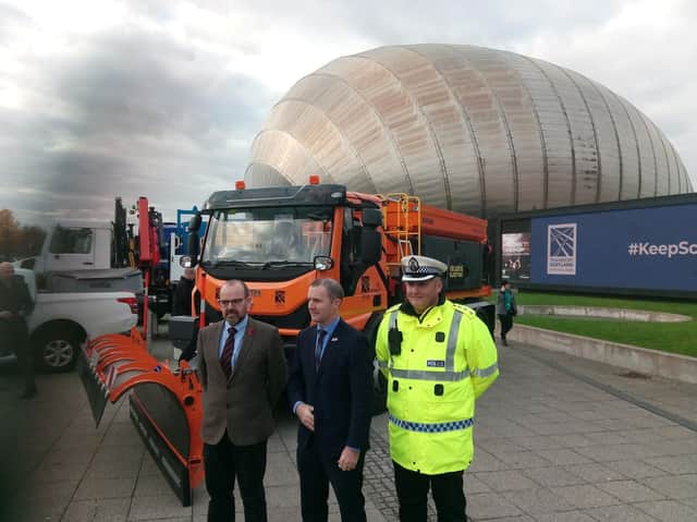 Transport secretary Michael Matheson, centre, with the world's first electric salt spreader at the Glasgow Science Centre today. Picture:The Scotsman