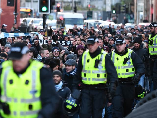 Lazio supporters are escorted to Celtic Park. Picture John Devlin