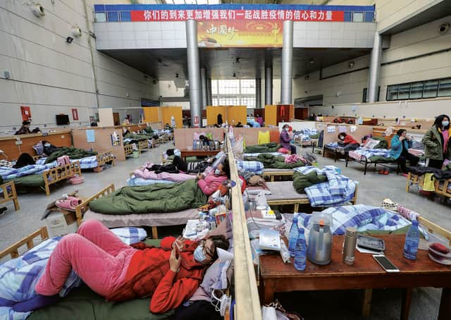 Patients rest at a temporary hospital at Tazihu Gymnasium in Wuhan in central China's Hubei province. Picture: Chinatopix/AP
