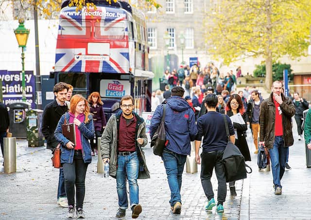 Students in Edinburgh's 
Bristo Square. Fewer EU applicants could mean more Scots getting free places. Picture: Ian Georgeson