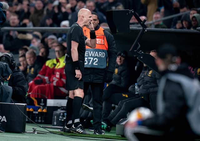 Referee Sergei Karasev checks the VAR monitor during Celtic’s match against FC Copenhagen. Photograph: Liselotte Sabroe/AFP/Getty