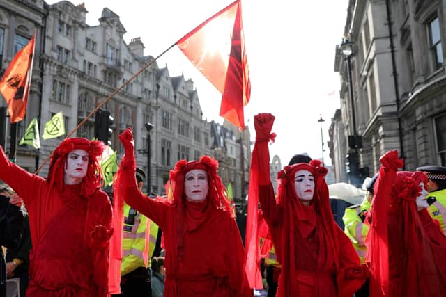 Extinction Rebellion protesters dressed in red costumes protesting over climate change in Trafalgar Square, London, last year. However, activists and others are also now turning to the courts as well Picture: AFP/Getty)