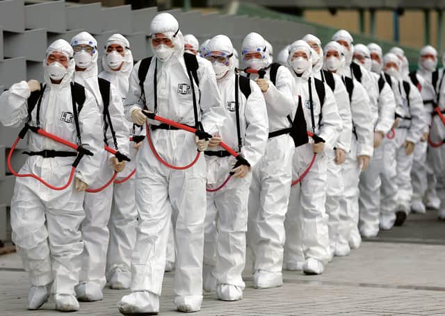 South Korean soldiers on a disinfectant patrol in Daegu, South Korea. Photograph: Yonhap/Getty