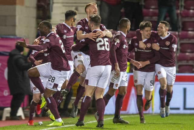 Jubilant Hearts players celebrate Oliver Bozanic's goal in Saturday night's Scottish Cup win over Rangers. Picture: Jeff Holmes/PA Wire