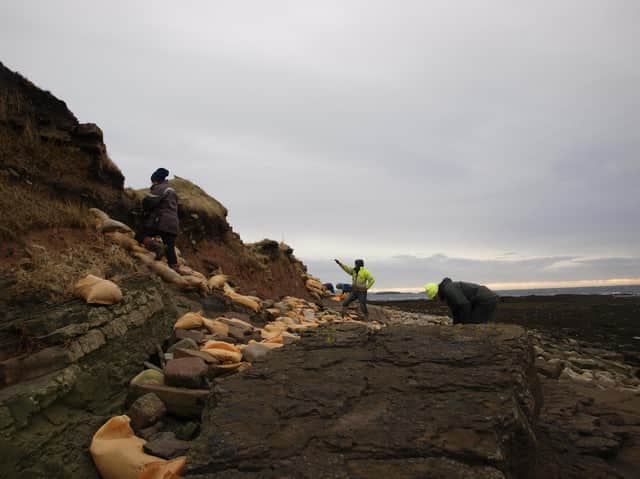 Volunteers work to secure the cemetery site at Newark on the Orkney mainland after storms exposed human remains. PIC: ORCA.