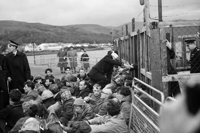 A protest at Holy Loch in 1961 with an attempt to pull an American sailor through the fence. PIC: TSPL.