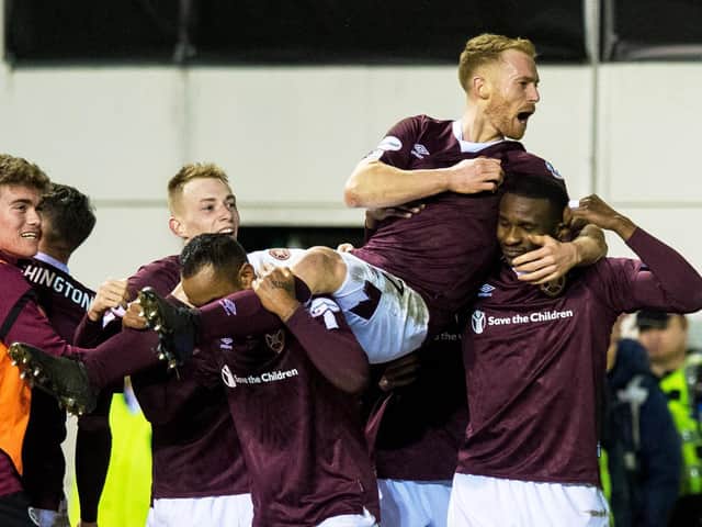 Oliver Bozanic is carried by his team-mates after putting Hearts 2-0 up