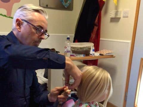 Agatha getting her hair cut by Jason Miller in 2015.