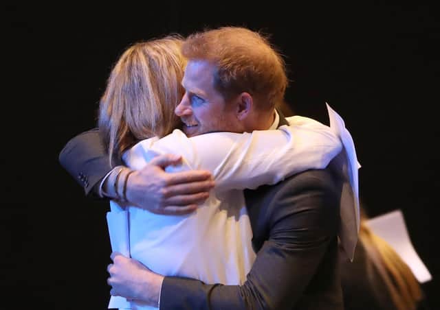 Harry gets a hug as he greets a guest at a sustainable tourism summit in Edinburgh International Conference Centre this week (Picture: Andrew Milligan-WPA Pool/Getty Images)